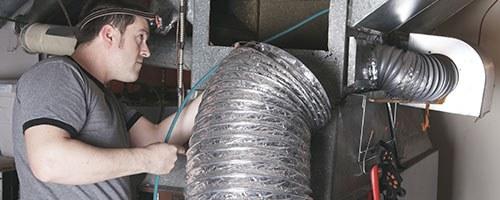 Technician working on air ducts